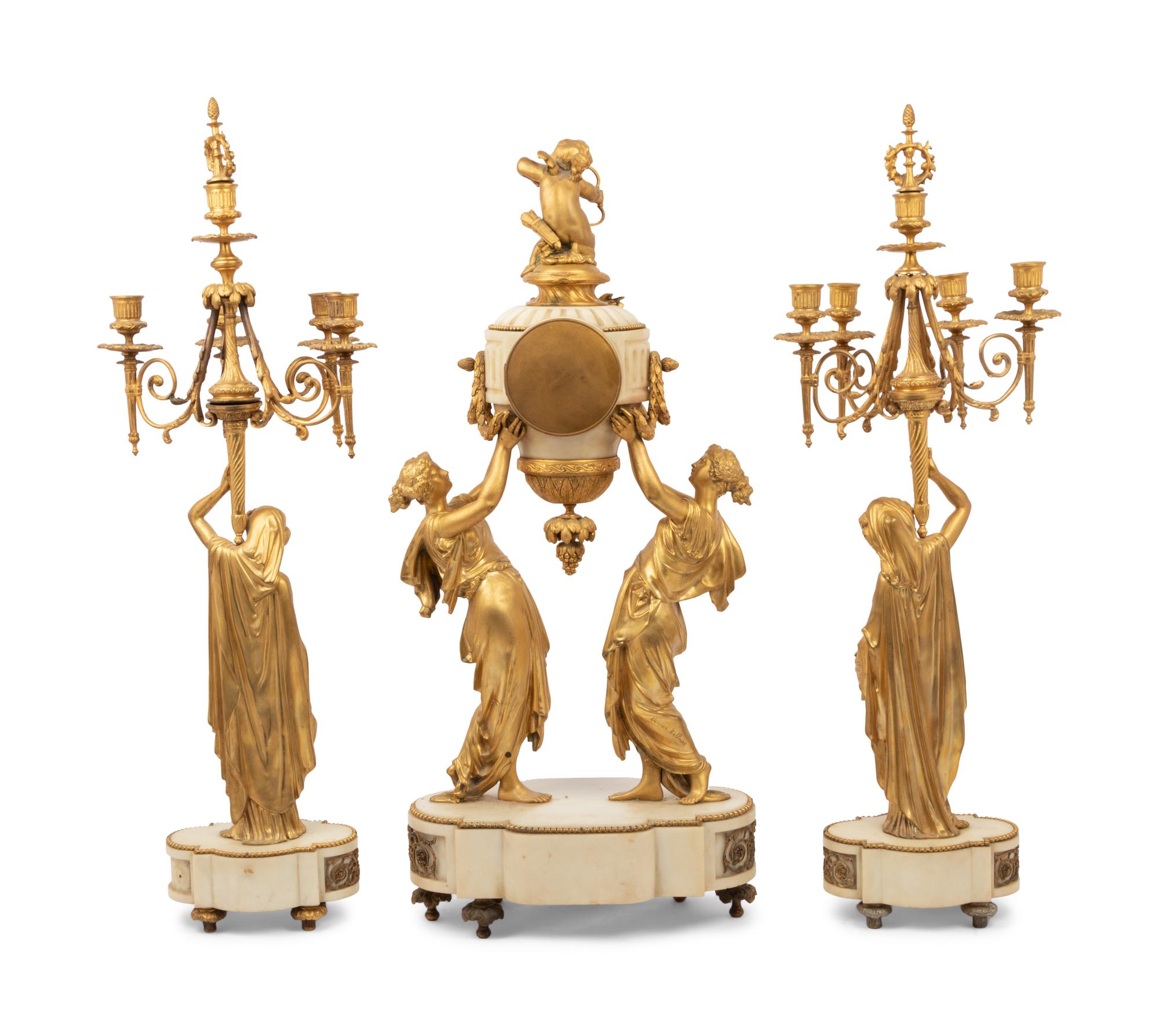A Louis XVI Style Gilt Bronze and Marble Figural Clock Garniture