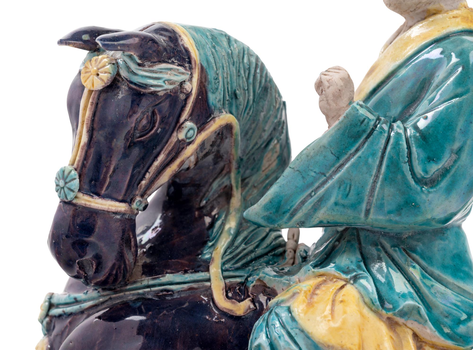 A Chinese Purple, Yellow and Blue Glazed Porcelain Equestrian Figure