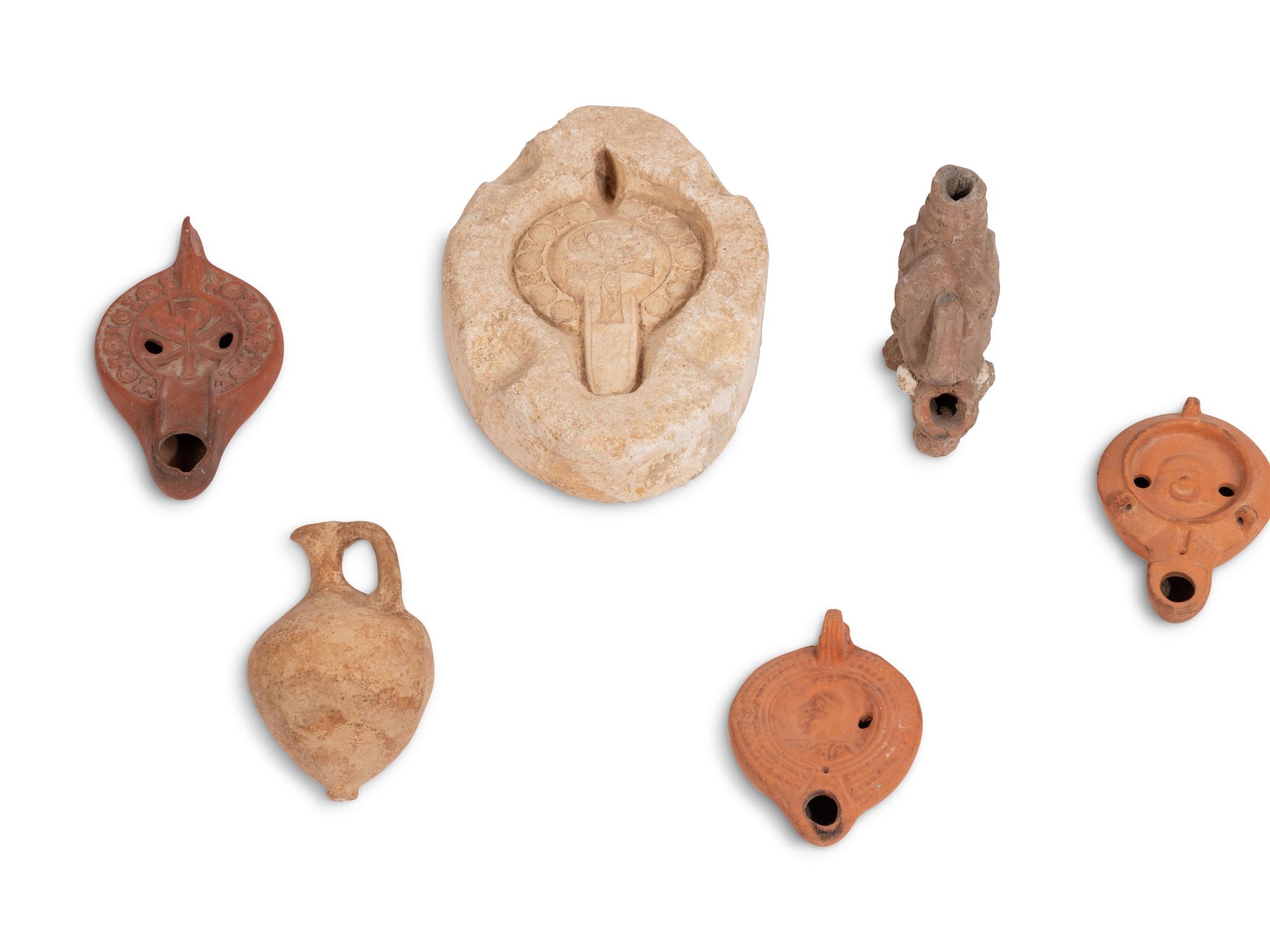 Ten Roman Terracotta Oil Lamps and a Holy Land Pottery Jug