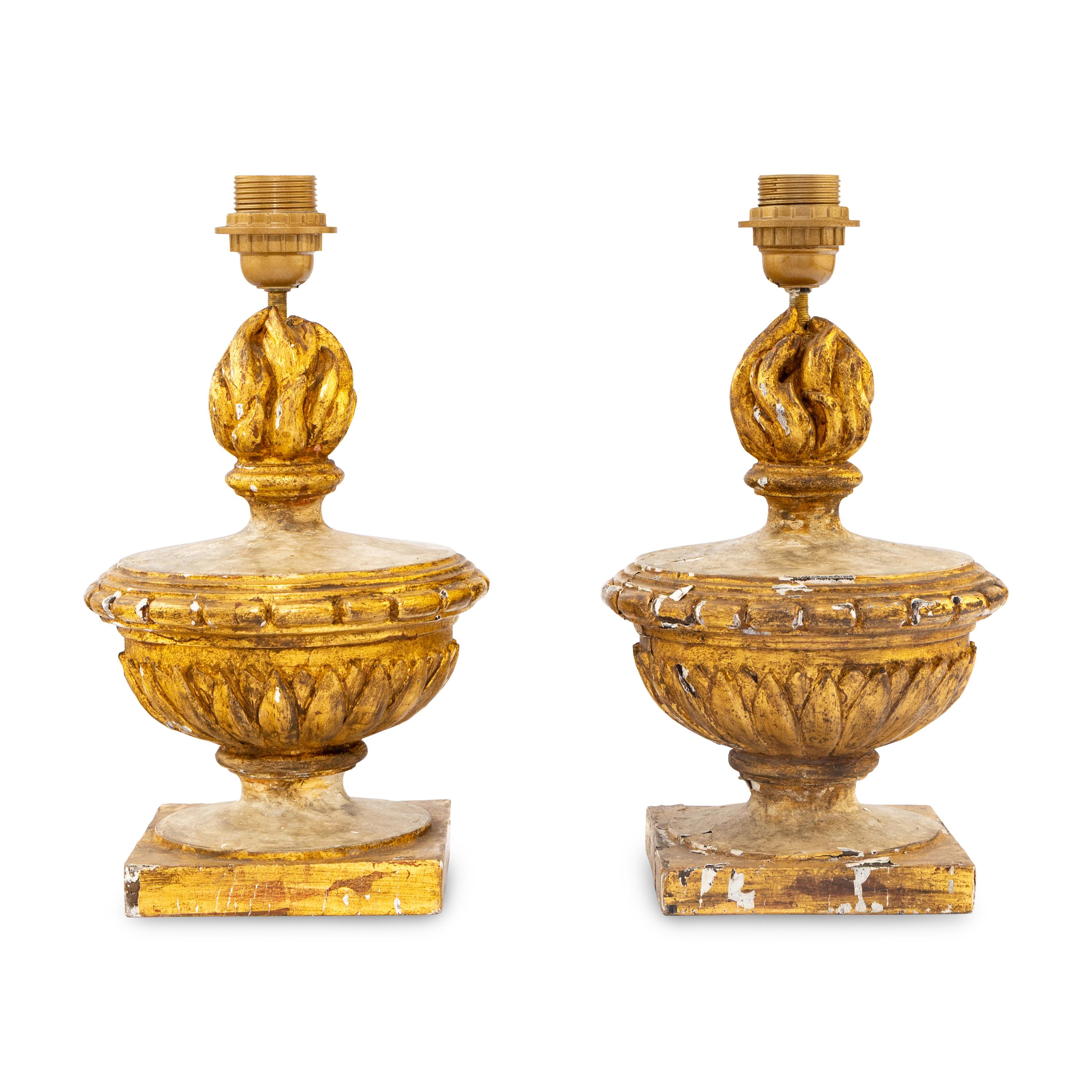 A Pair of Neoclassical Painted and Parcel-Gilt Wood Flaming Urn Finials