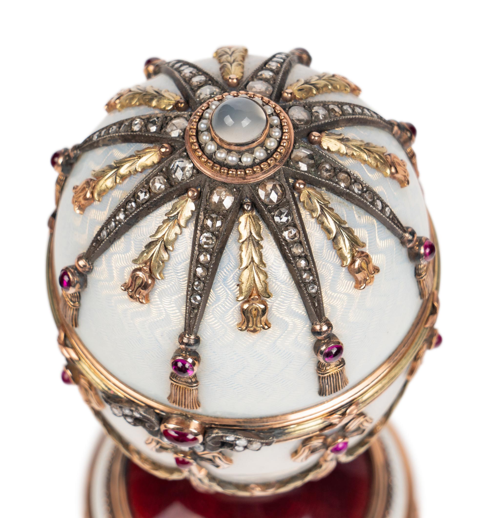 A 14 Karat Vari-Color Gold, Silver, Guilloché Enamel, Diamond, Pearl, and Cabochon Jewel-Mounted Surprise Egg