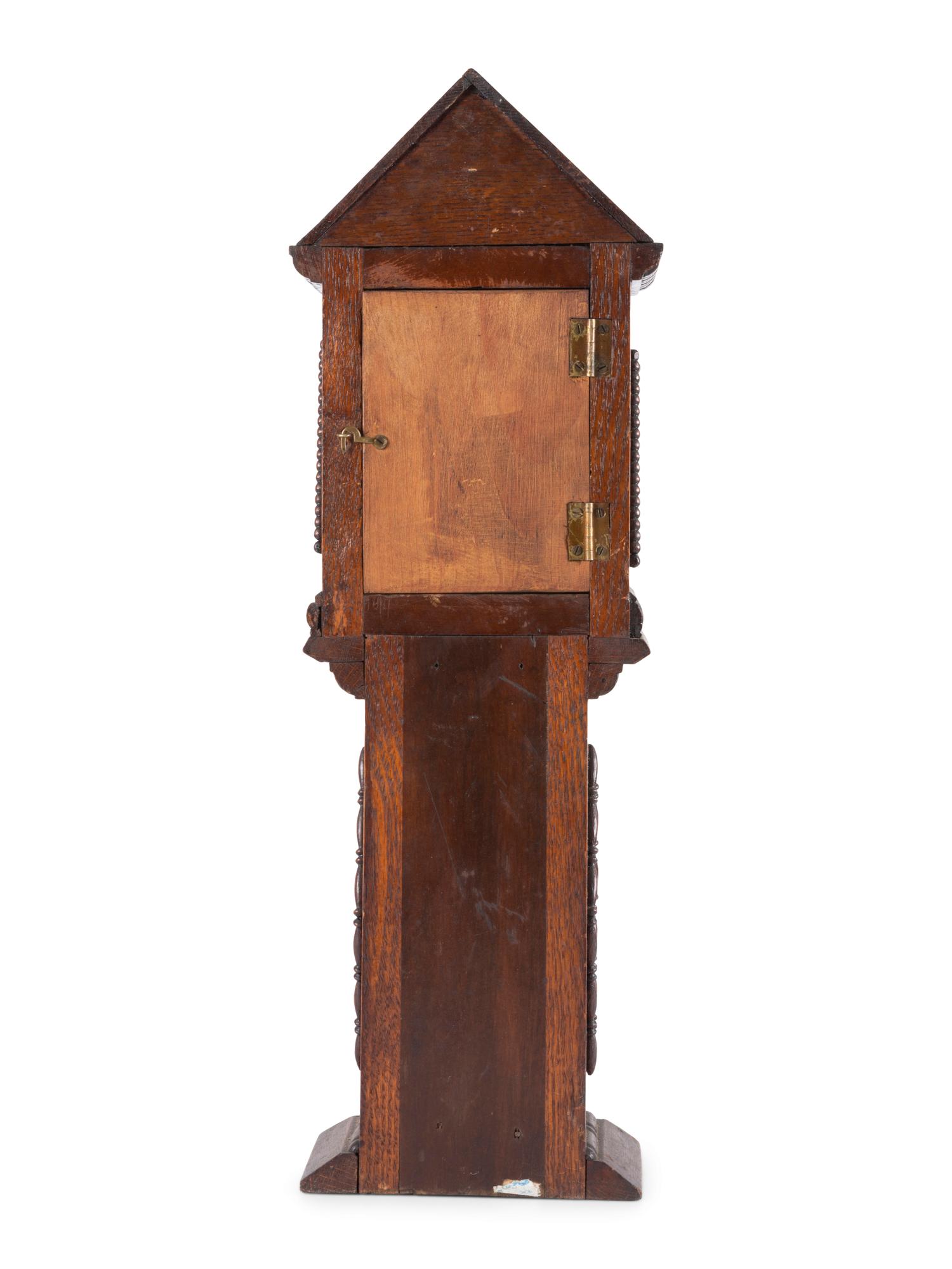 A Miniature Carved Tall Case Clock