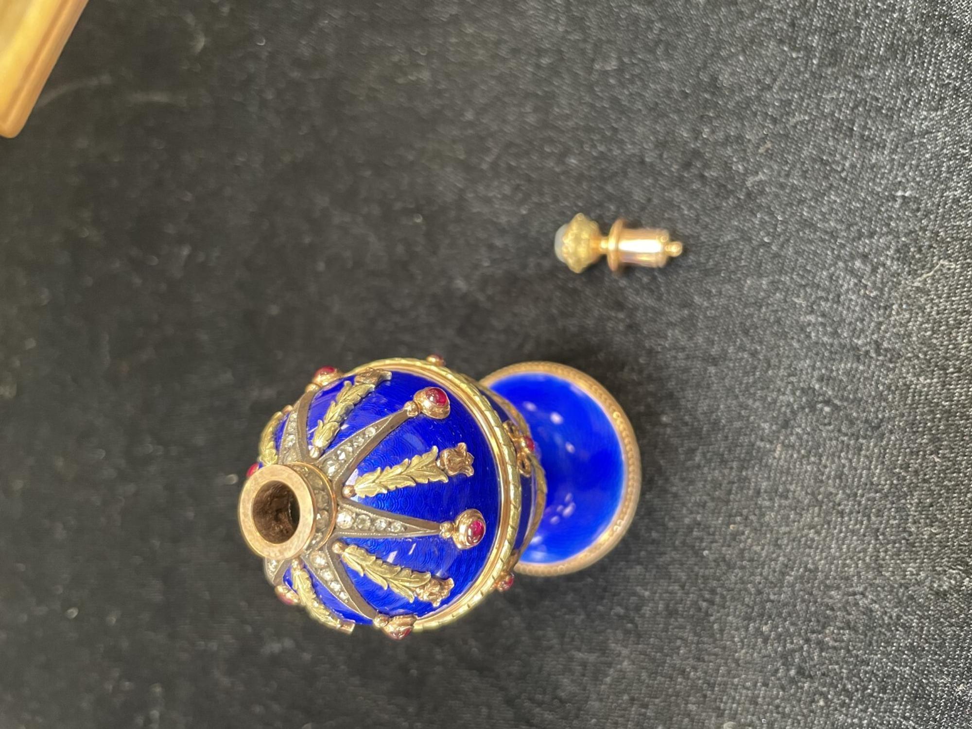 A 14 Karat Vari-Color Gold, Guilloché Enamel, Diamond, and Cabochon Jewel-Mounted Egg-Form Perfume and a Related Guilloché Enamel, 14 Karat Vari-Color Gold, Diamond, and Cabochon-Mounted Surprise Egg