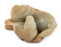 A Chinese Celadon and Russet Jade Carving of Two Mythical Beasts