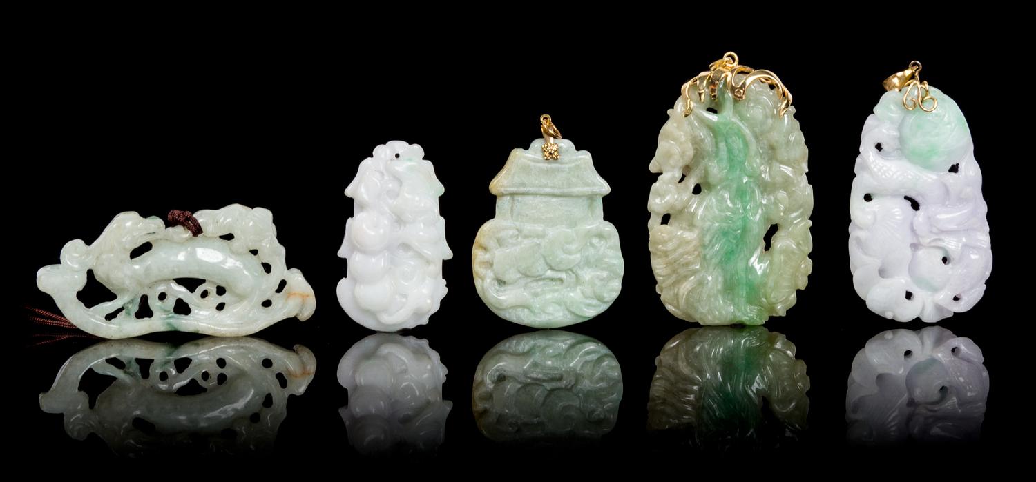 Five Carved Jadeite Pendants Height of largest 2 1/2 inches.