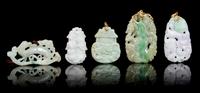 Five Carved Jadeite Pendants Height of largest 2 1/2 inches.