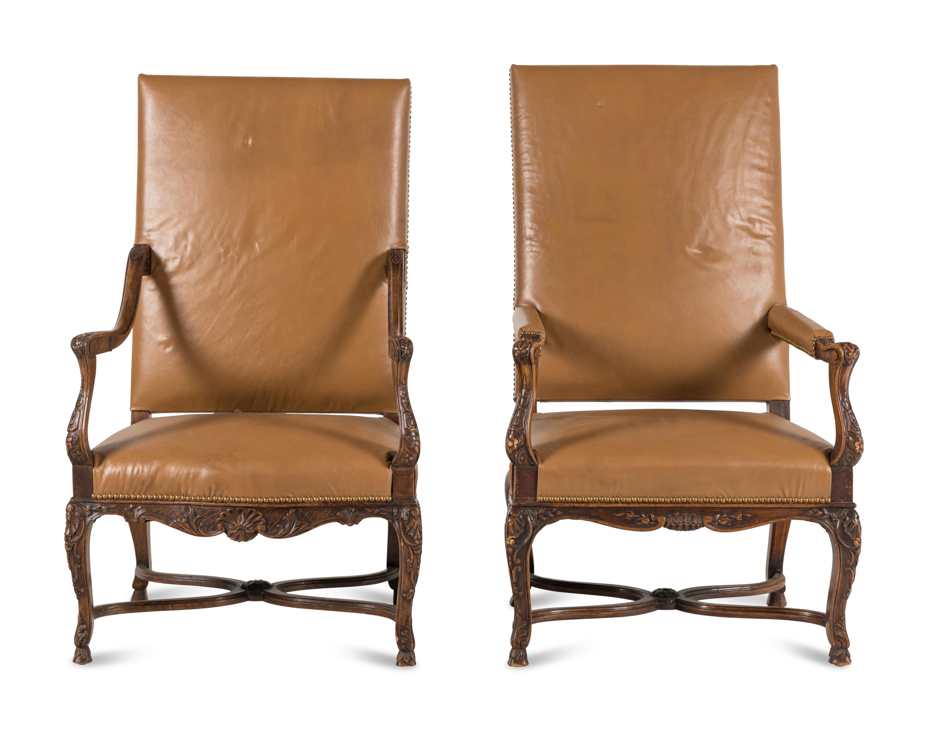 A Matched Pair of Régence Style Walnut Fauteuils