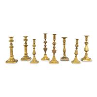 A Collection of Eight Continental Brass Candlesticks