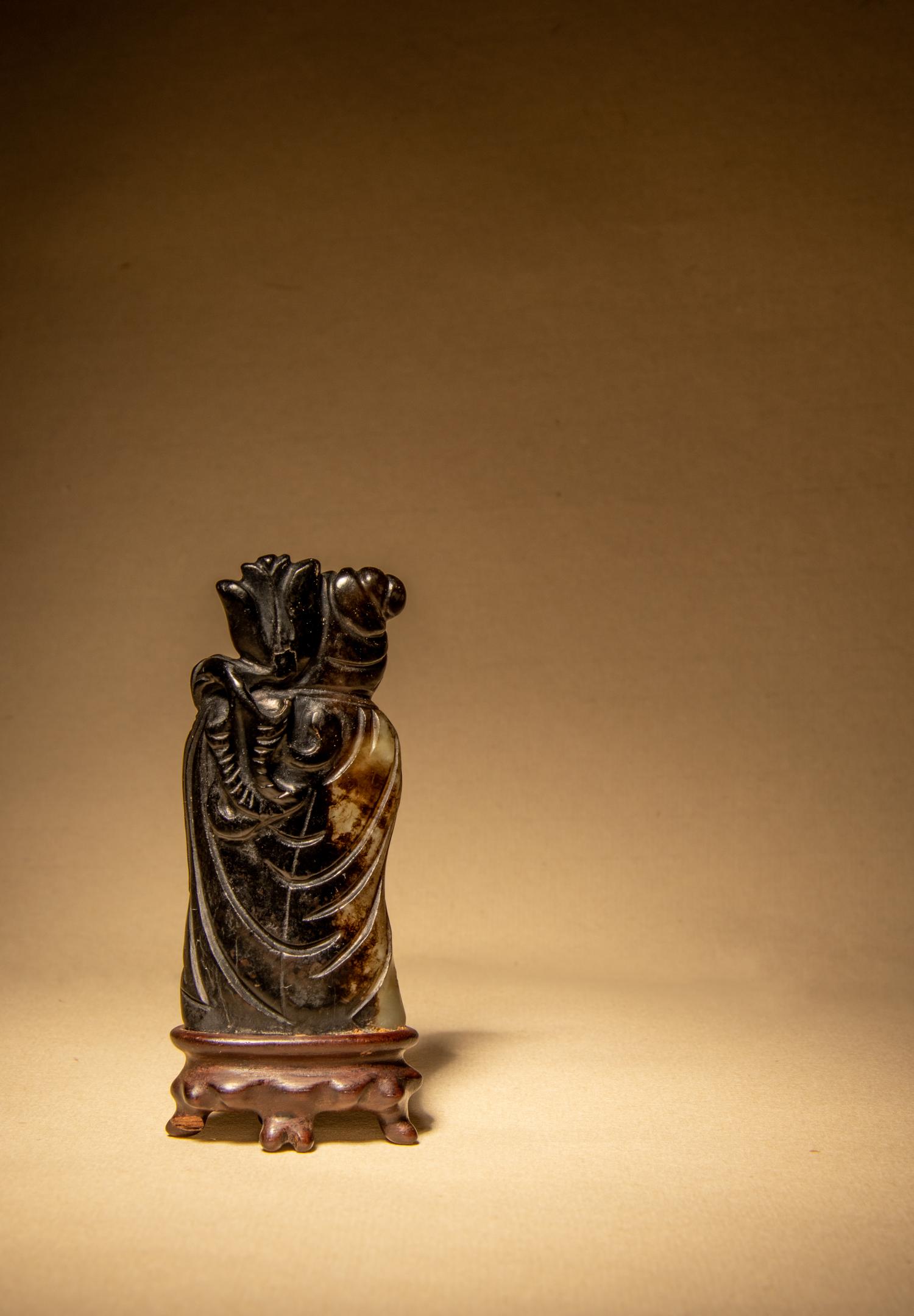 A Black and Grey Jade Figure of a Foreigner