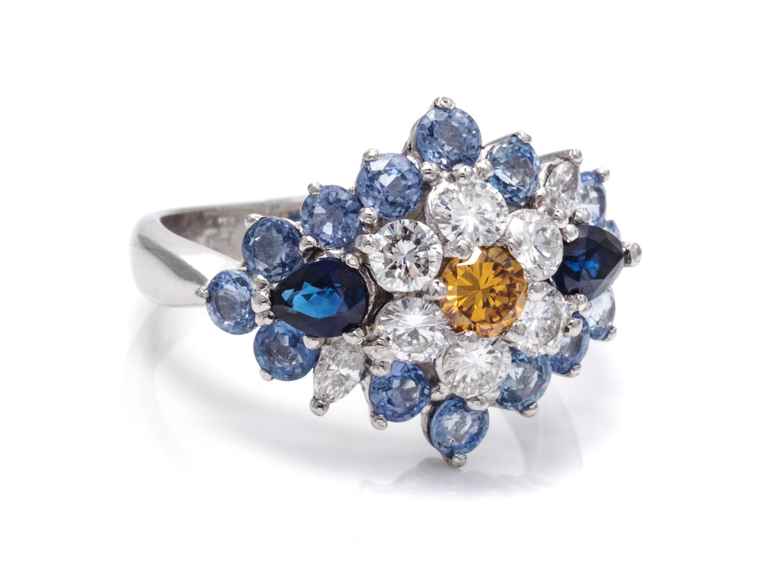 An 18 Karat White Gold, Colored Diamond, Diamond and Sapphire Ring,