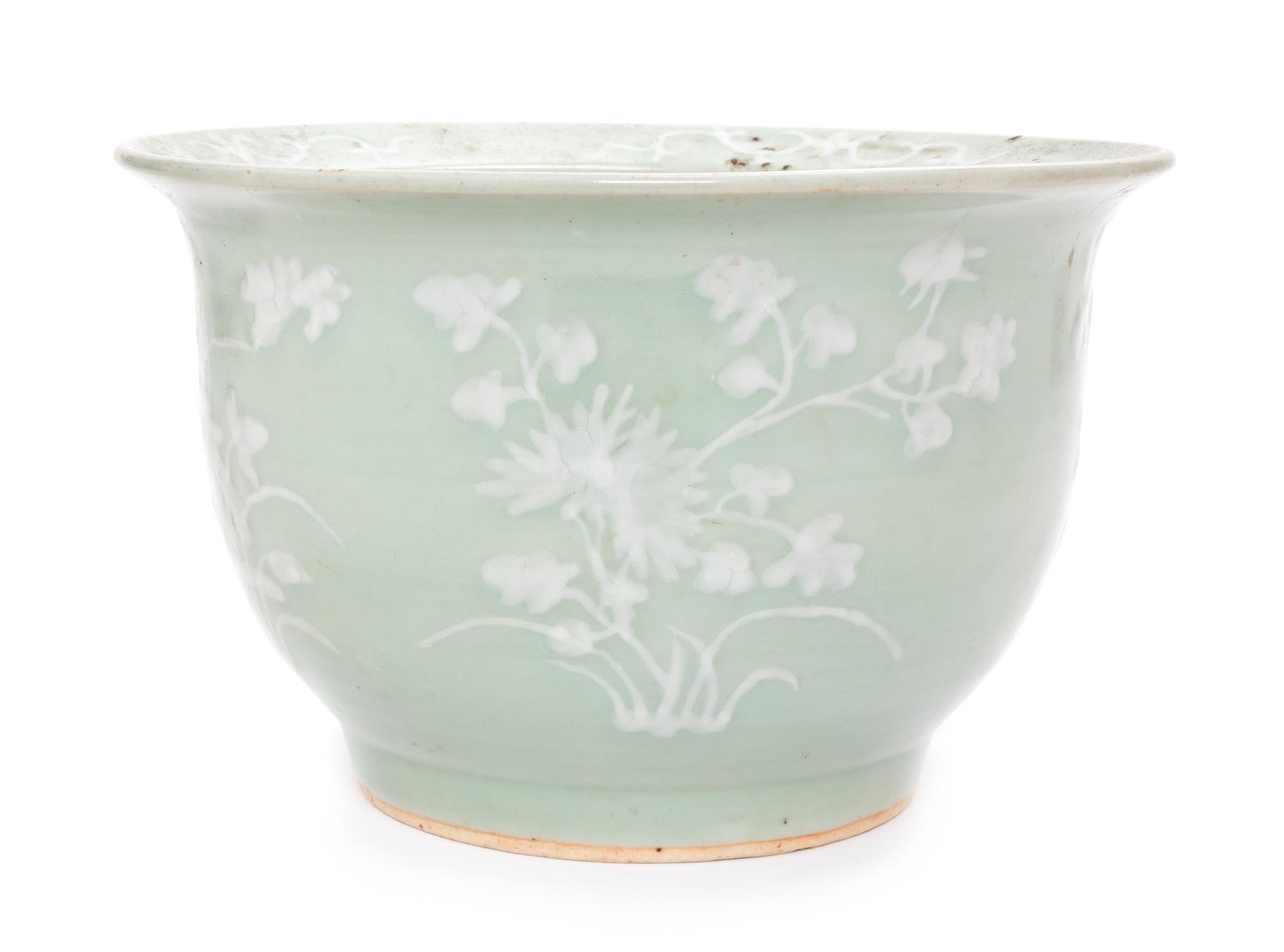 A Chinese White Slip Decorated Celadon Ground Cachepot Height 11 1/2 inches.
