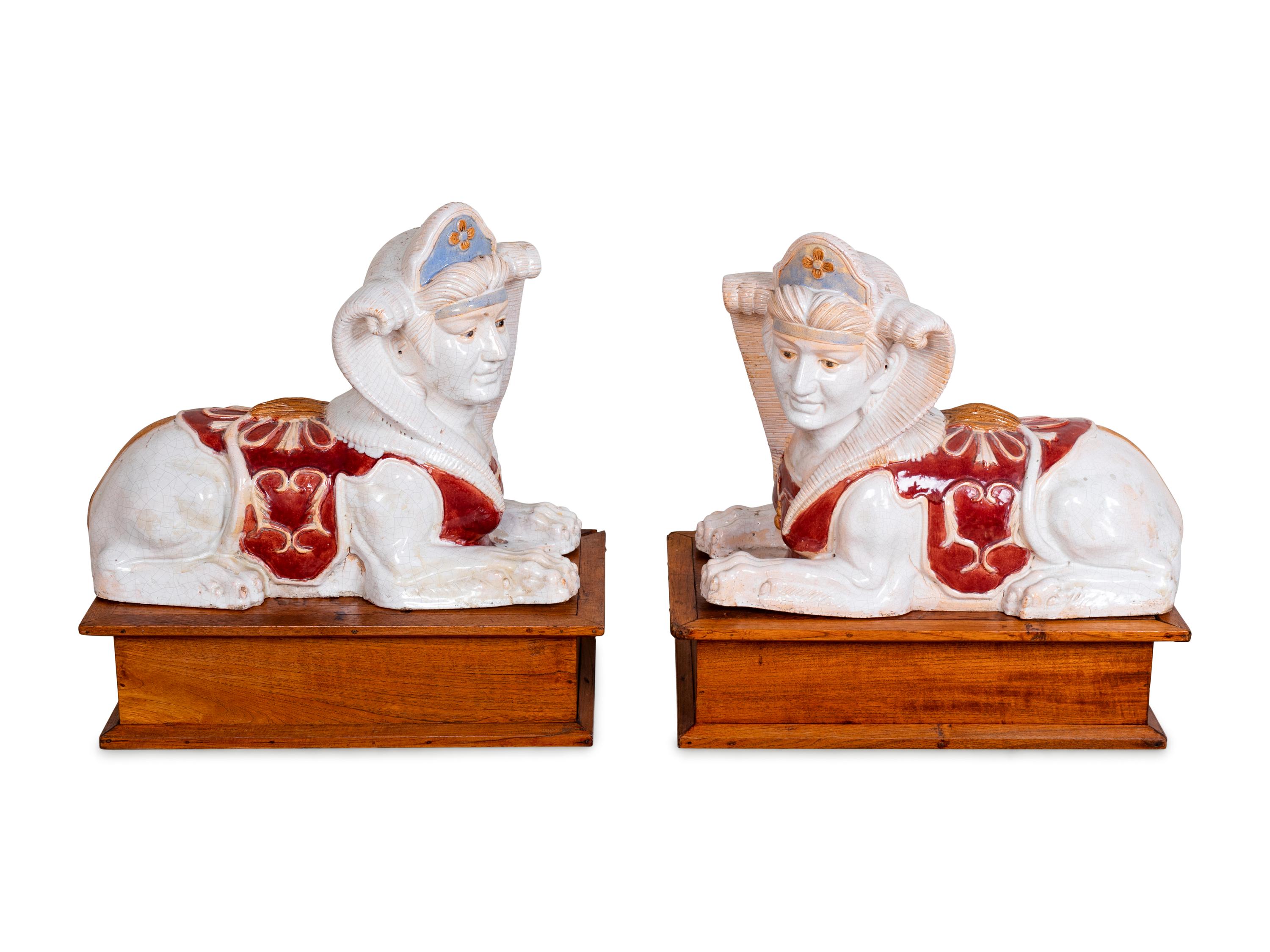 A Pair of Polychromed Ceramic Sphinxes — 20TH CENTURY