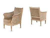 A Pair of Louis XVI Cream-Painted and Parcel Gilt Bergères