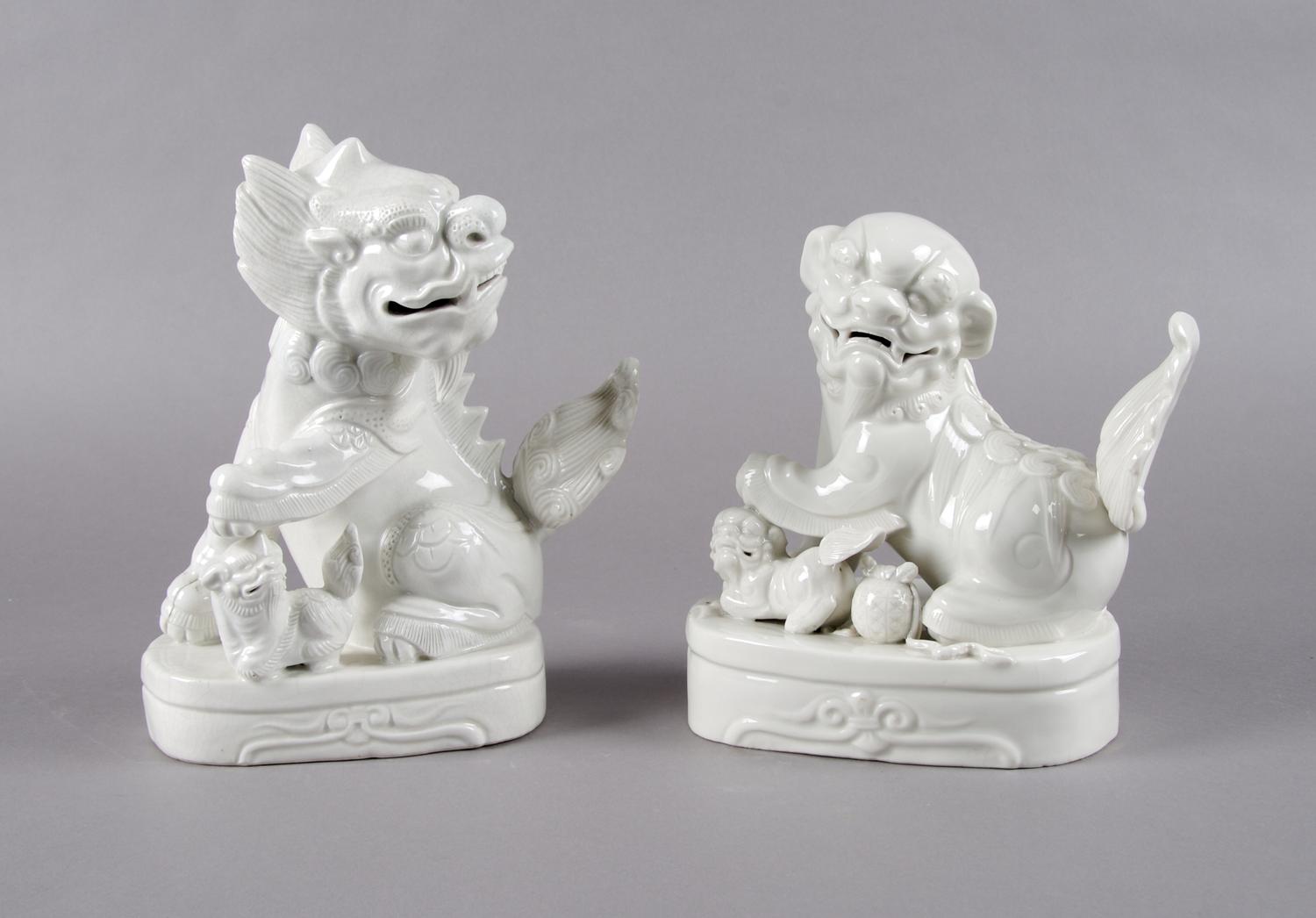 A Pair of Chinese Blanc de Chine Foo Dogs, Height 7 1/2 inches.