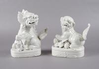 A Pair of Chinese Blanc de Chine Foo Dogs, Height 7 1/2 inches.