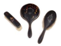 An English Silver and Tortoise Shell Three-Piece Dresser Set, G. W. Lewis & Co., Birmingham, 1919-25, comprising two brushes and a hand