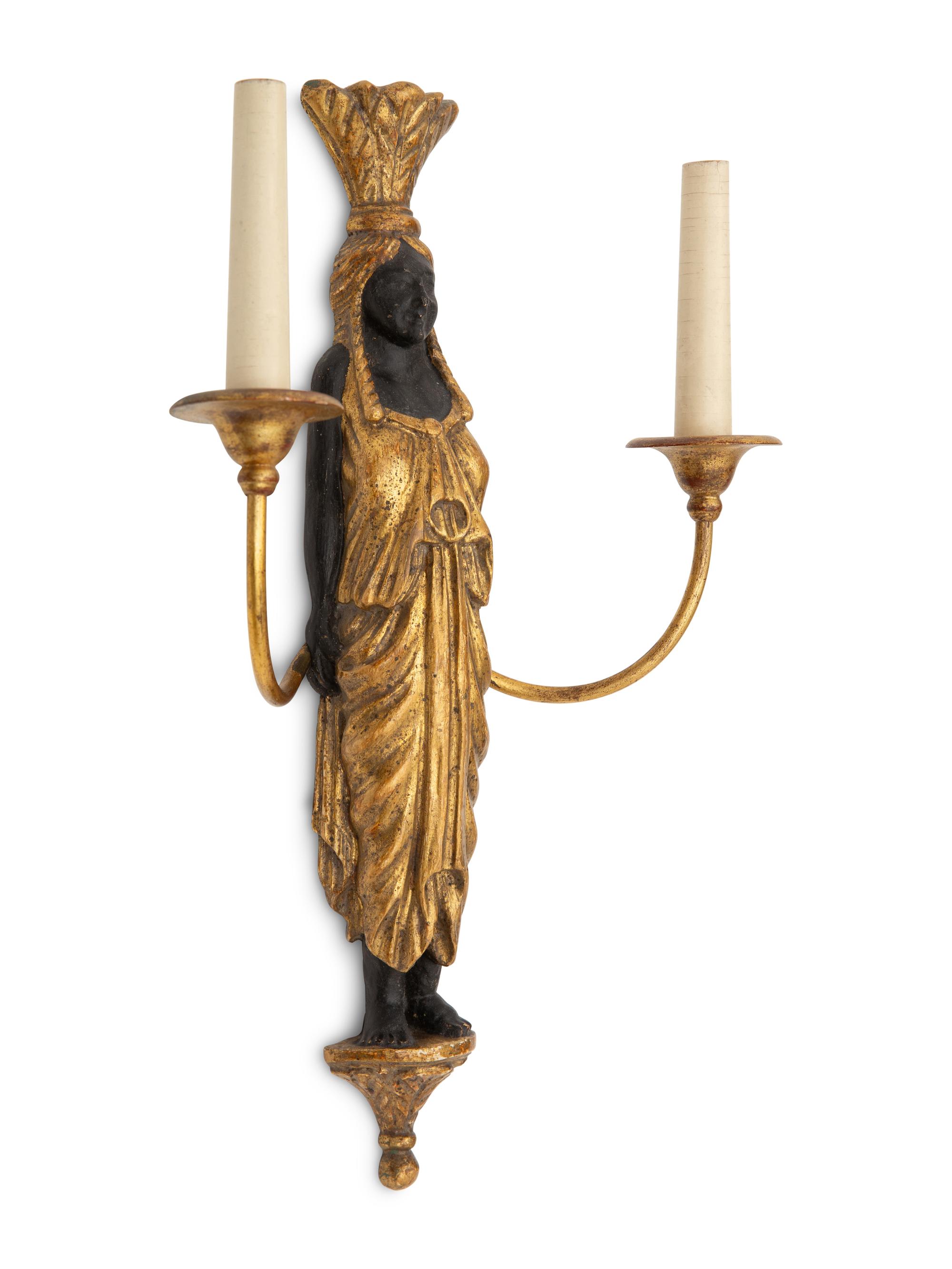 A Pair of Continental Empire Style Ebonized and Parcel Gilt Two-Light Figural Sconces