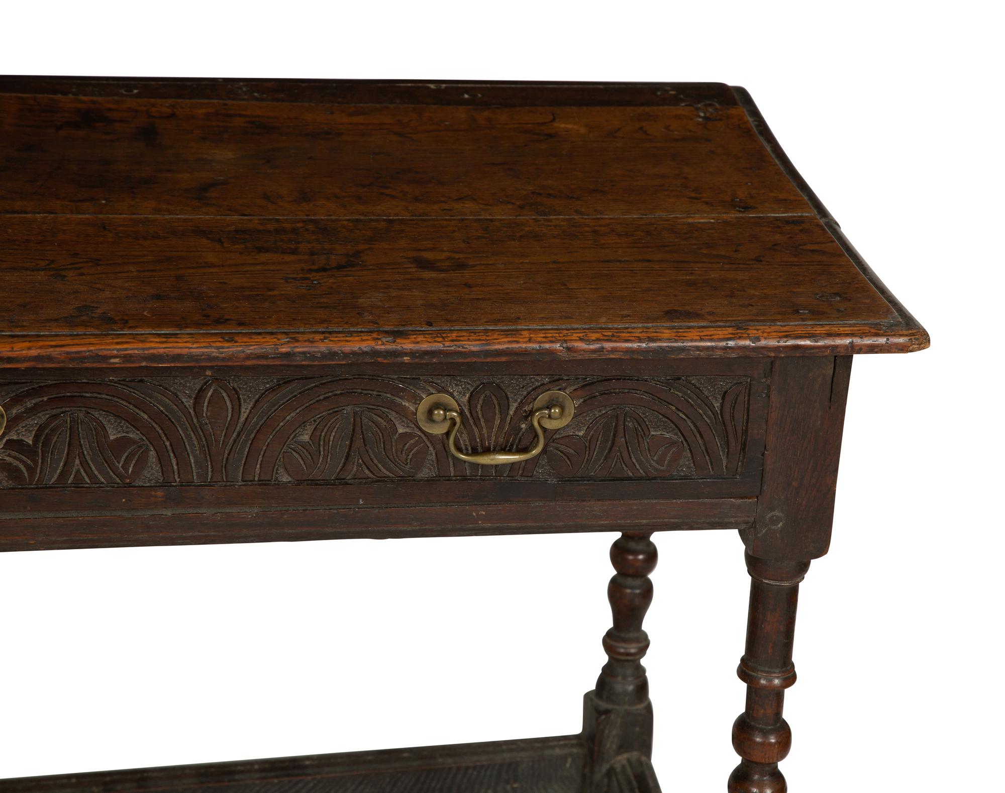 A Jacobean Style Carved Oak Writing Table and a Similar Stool with Flip Top