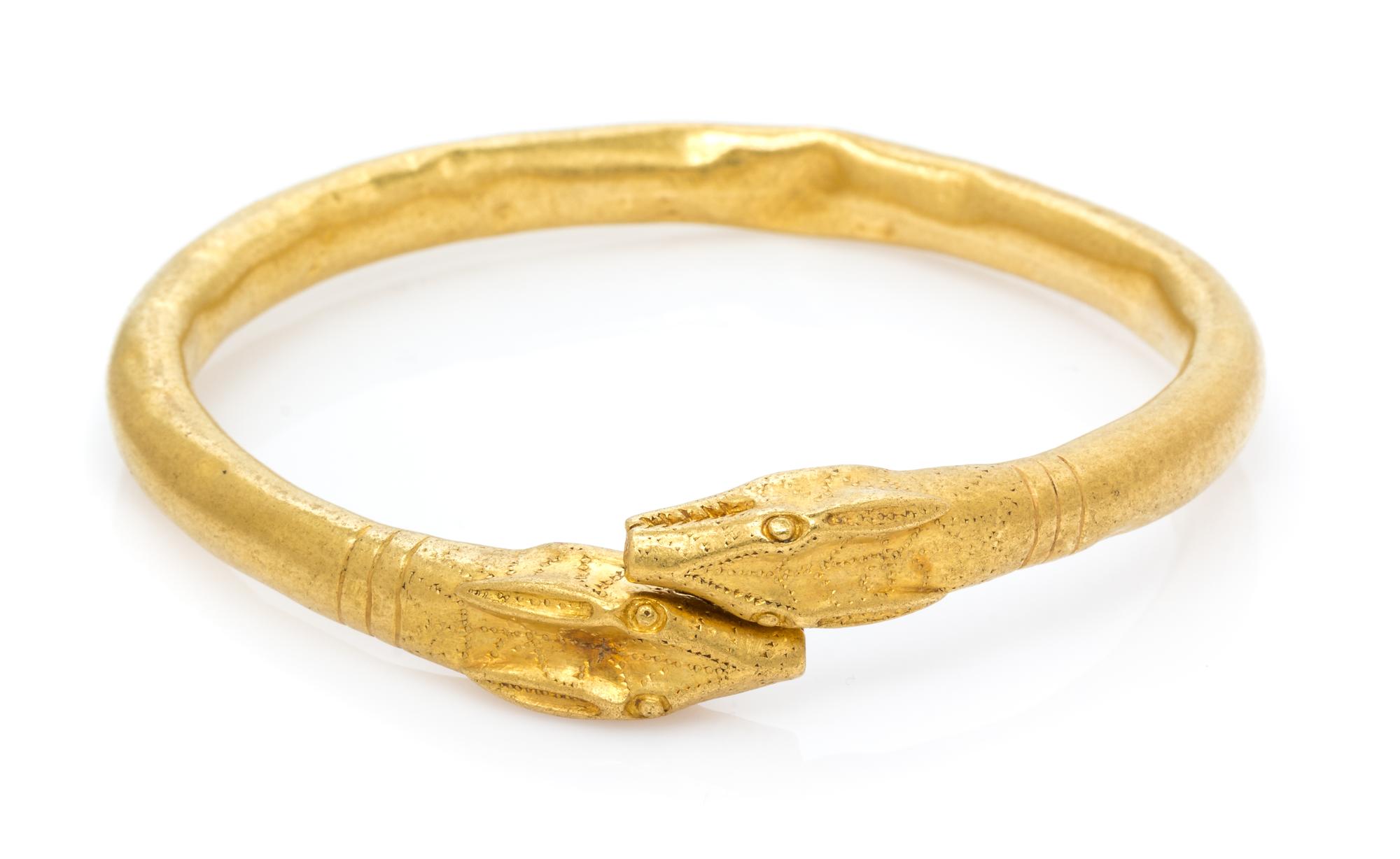 A Possibly Ancient High Karat Gold Animal Head Motif Armband, 32.30 dwts.