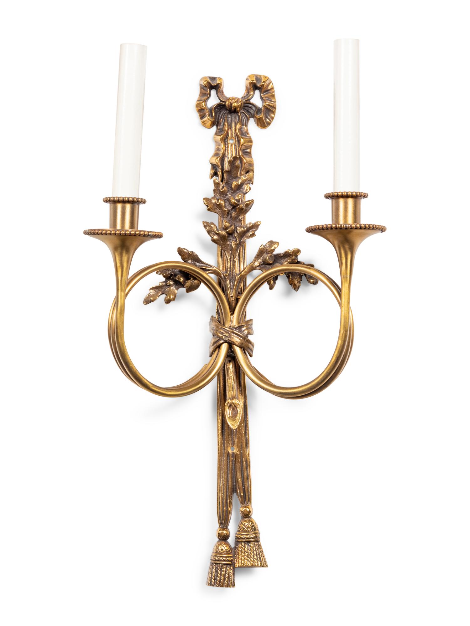 A Set of Seven Louis XVI Style Brass Two-Light Sconces