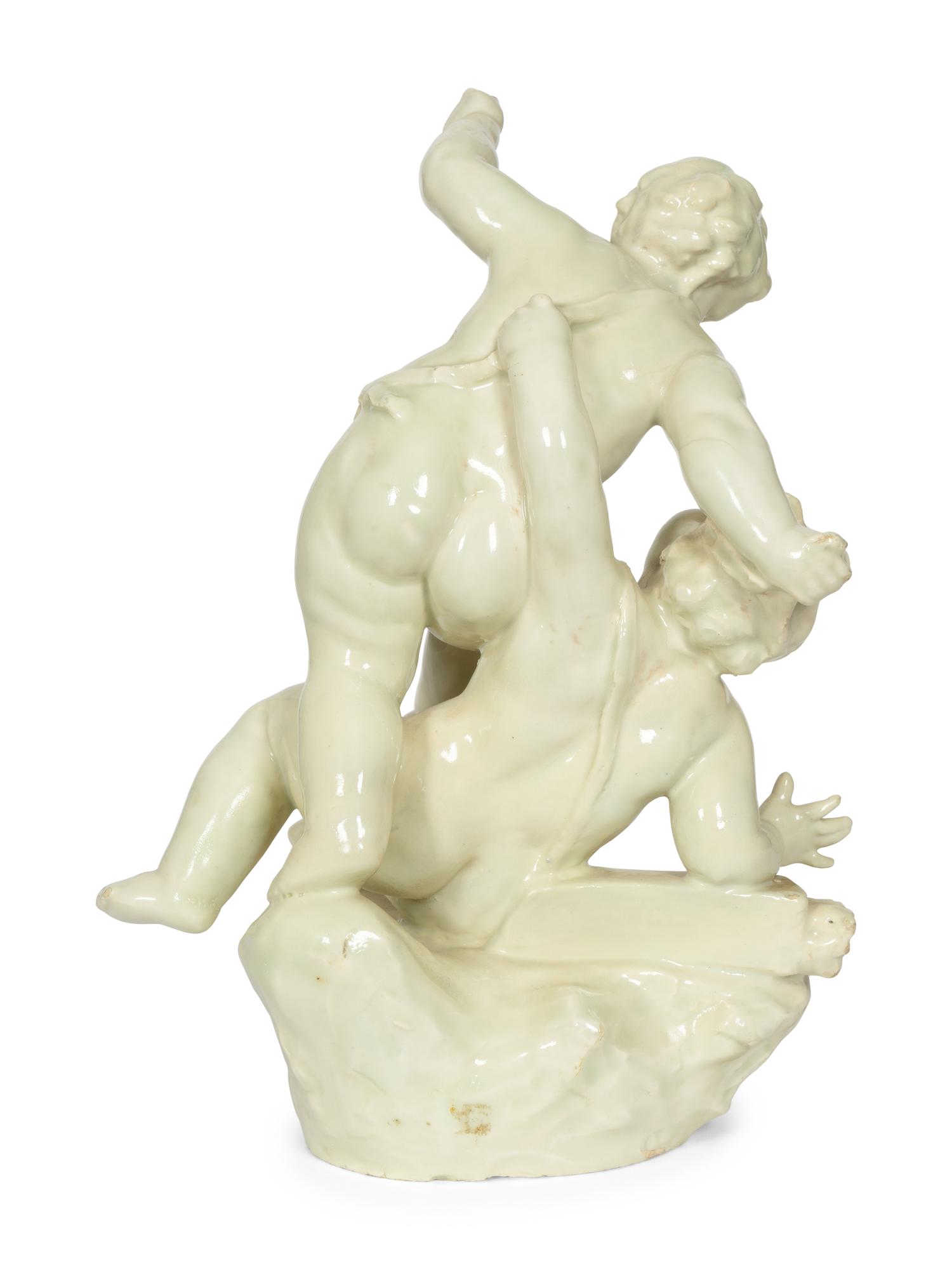 A Continental White-Glazed Faience Putti Group