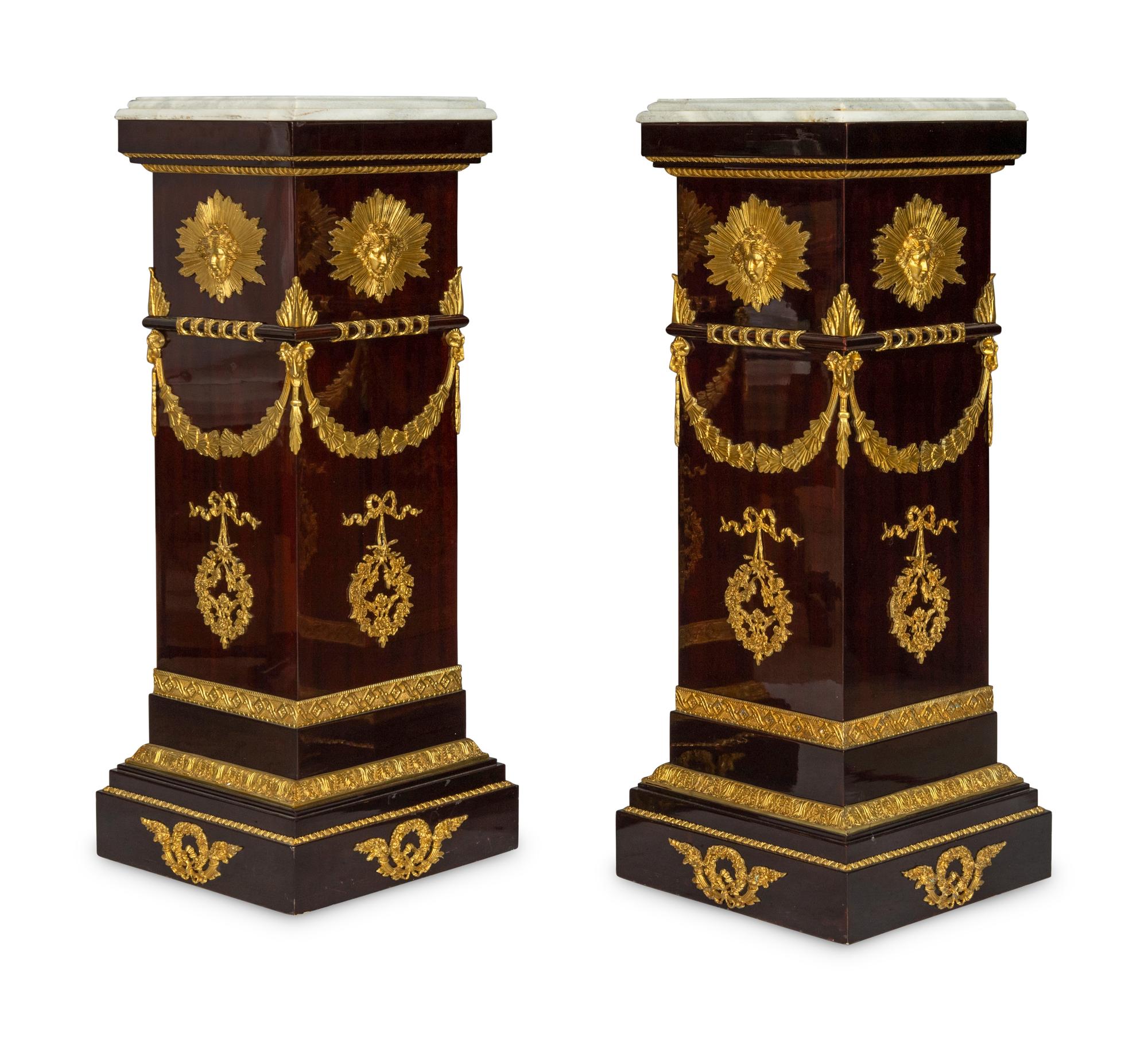 A Pair of Monumental Empire Style Gilt Bronze Mounted Mahogany Pedestals