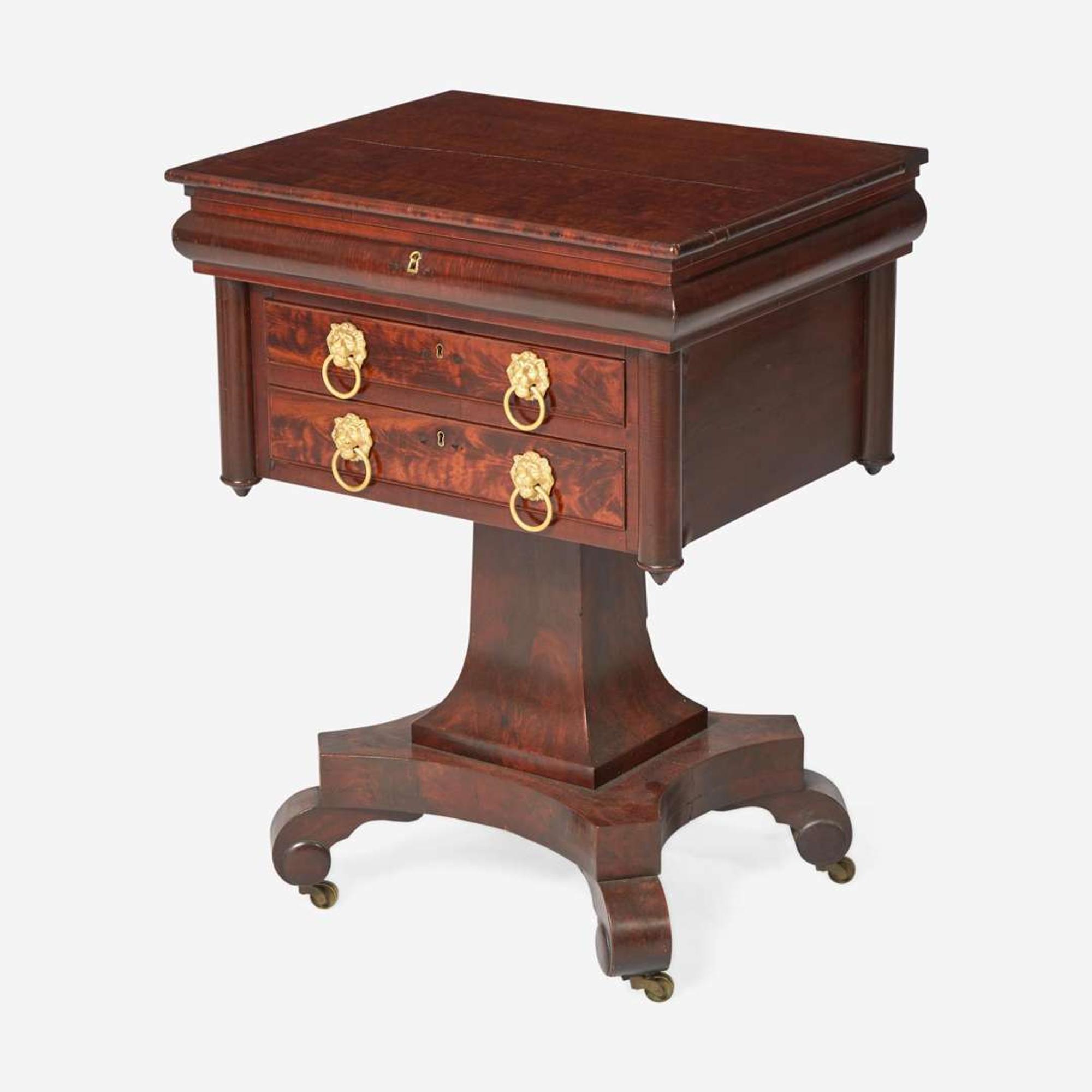 A Classical carved mahogany work table together with Regency mahogany tea caddy The table probably Baltimore, MD, circa 1820-1830
