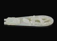 A Chinese carved pale celadon jade belt hook, Qing dynasty 青玉帶鉤 清