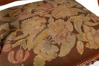 A Pair of Régence Style Carved Walnut Fauteuils