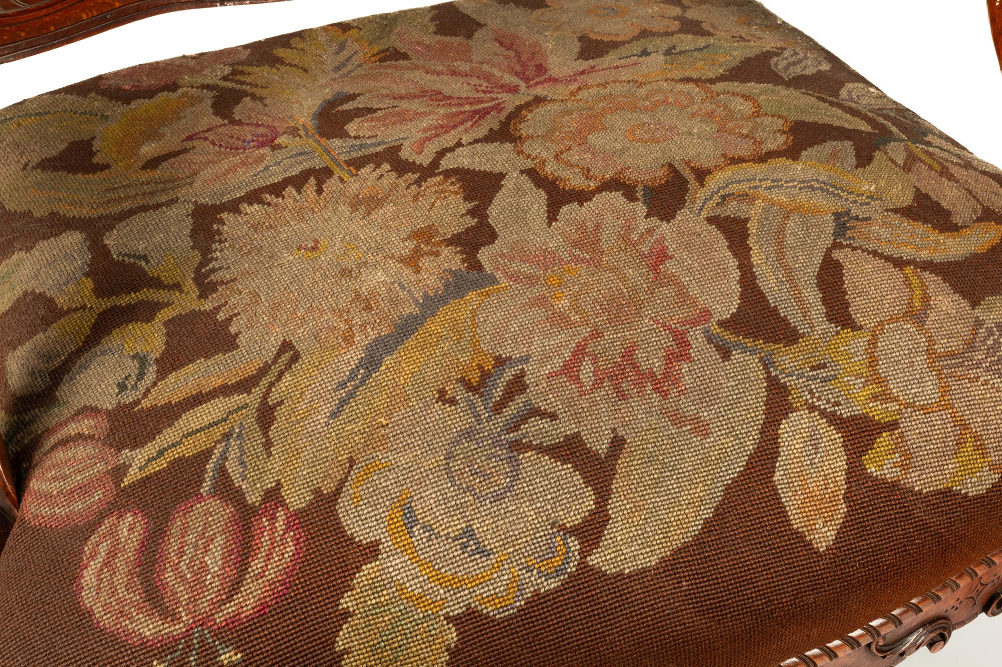 A Pair of Régence Style Carved Walnut Fauteuils