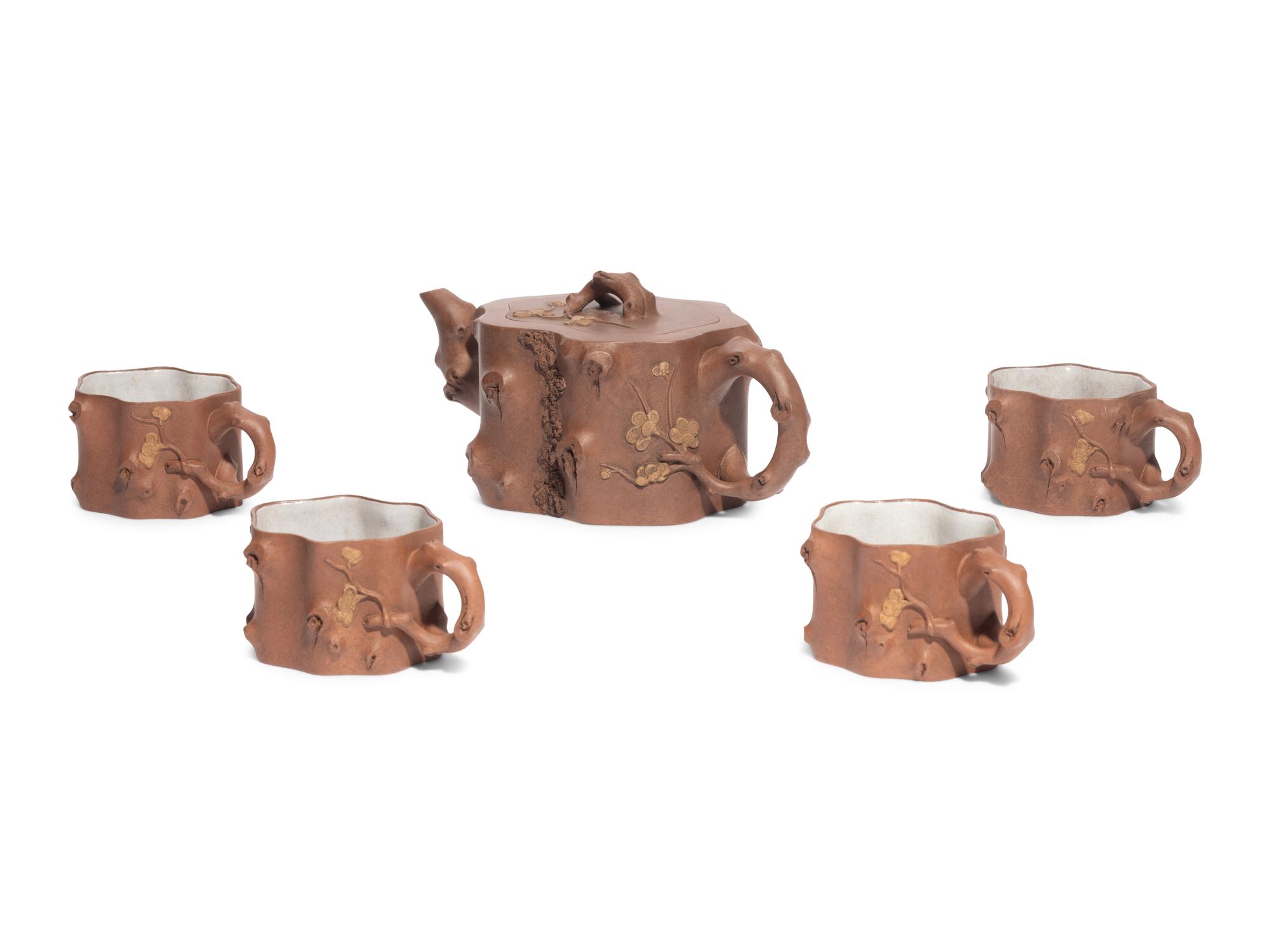 A Chinese Yixing Zisha Pottery Teapot and Four Teacups