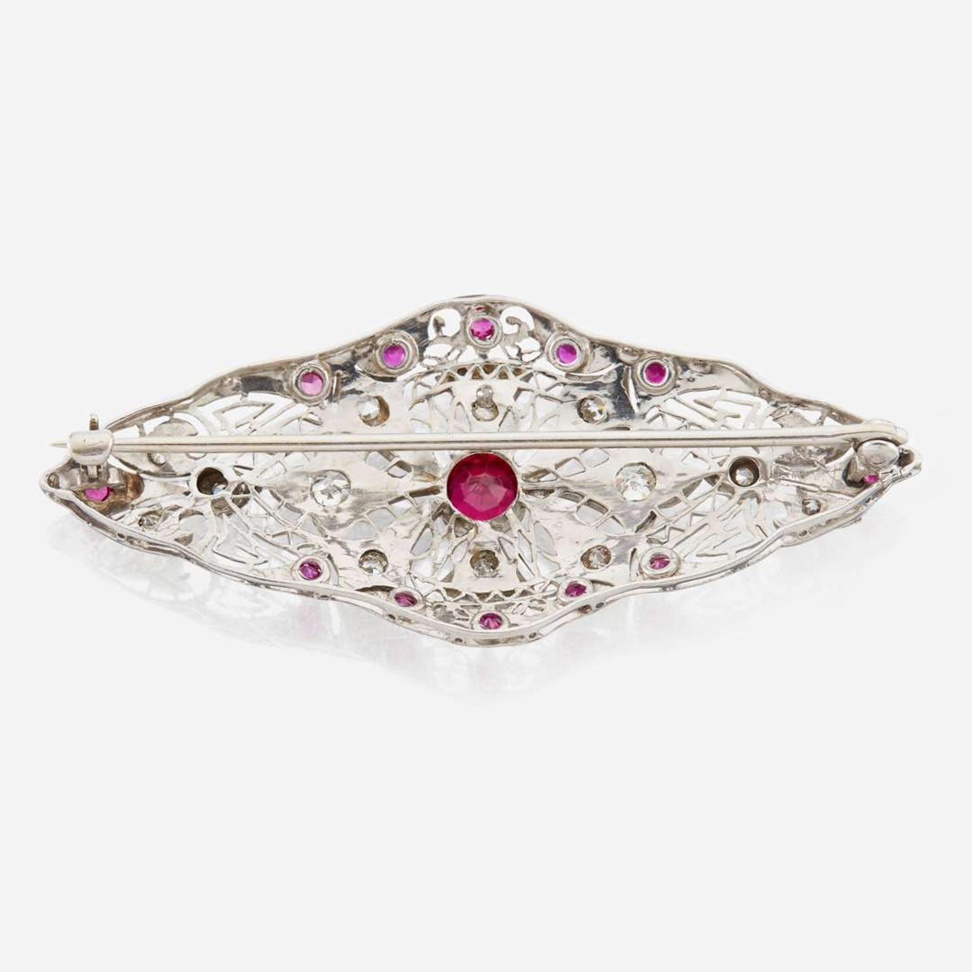 A platinum, diamond, and ruby brooch