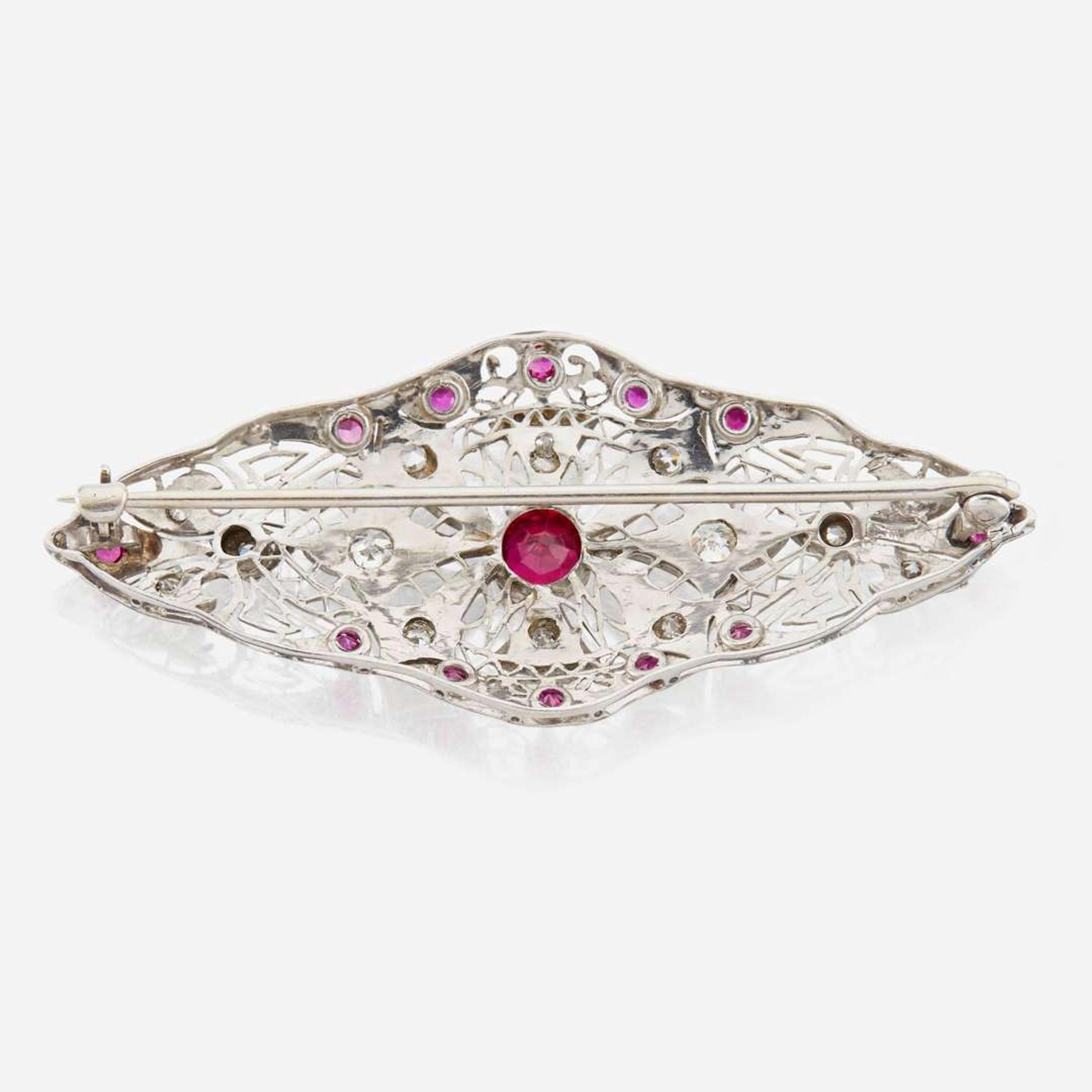 A platinum, diamond, and ruby brooch
