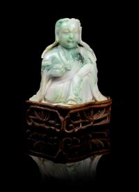 A Chinese Jadeite Figure of Guanyin LATE 19TH/EARLY 20TH CENTURY Height of jade 4 3/4 x width 4 1/2 inches. — LATE 19TH/EARLY 20TH CENTURY