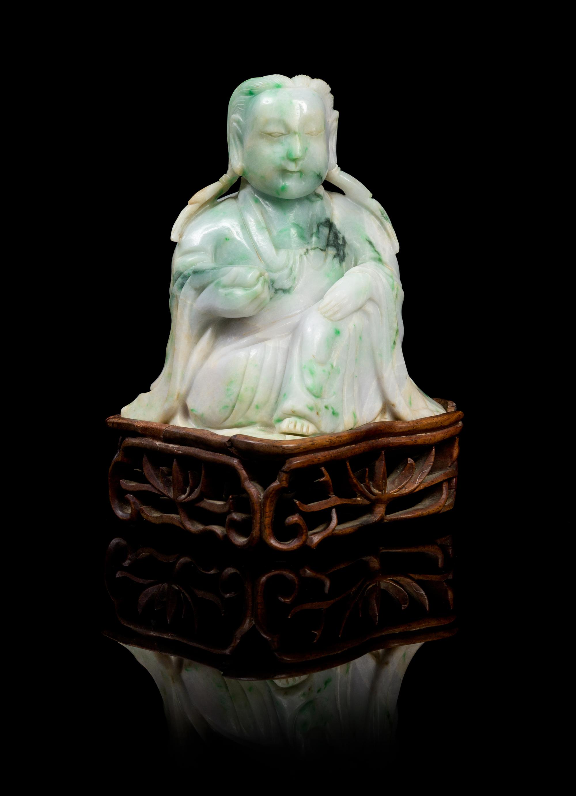 A Chinese Jadeite Figure of Guanyin LATE 19TH/EARLY 20TH CENTURY Height of jade 4 3/4 x width 4 1/2 inches. — LATE 19TH/EARLY 20TH CENTURY