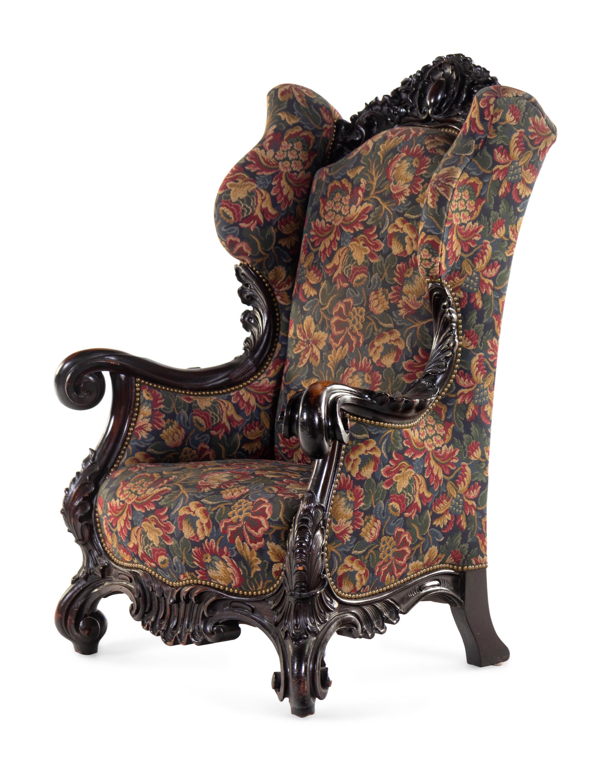 A Karpen Carved Mahogany Wingback Armchair
