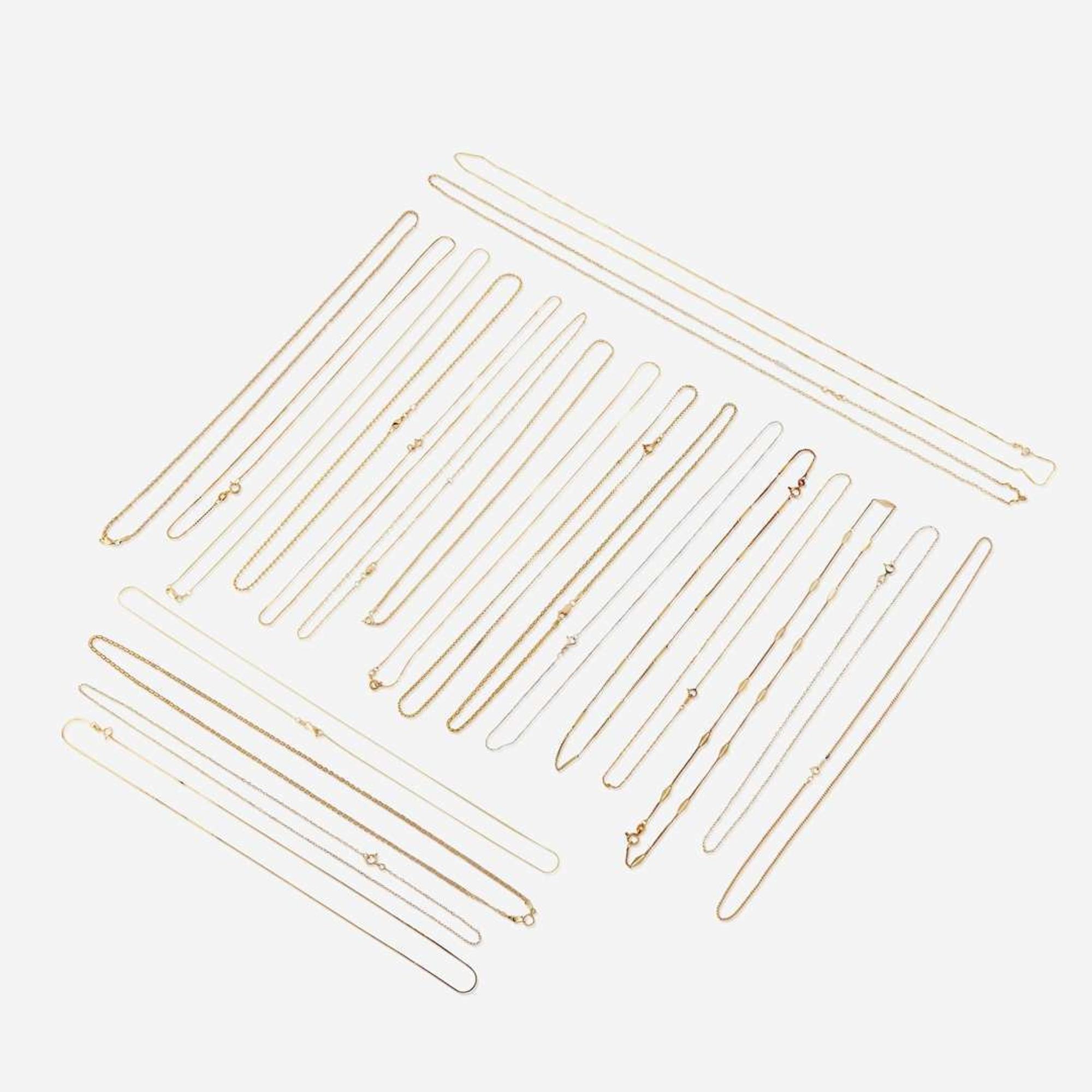 A collection of twenty-two fourteen karat gold necklaces