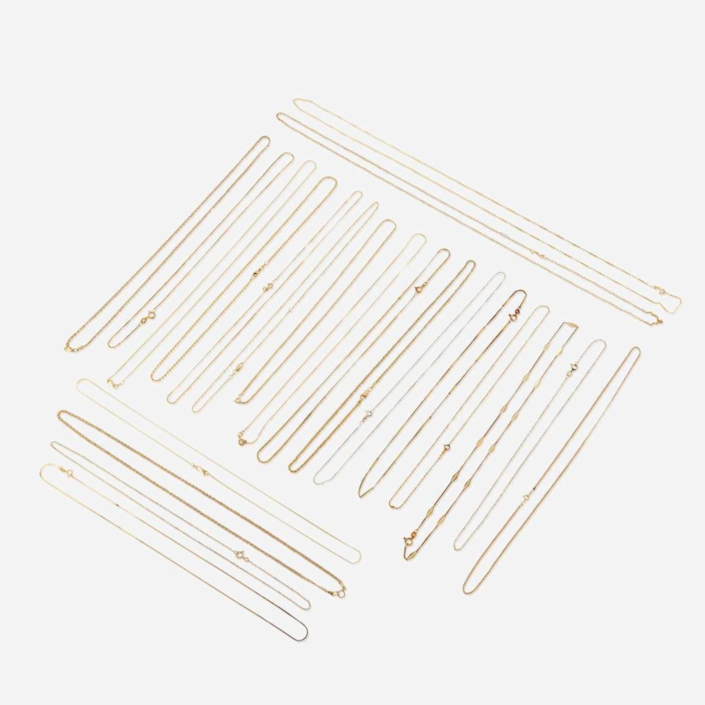 A collection of twenty-two fourteen karat gold necklaces
