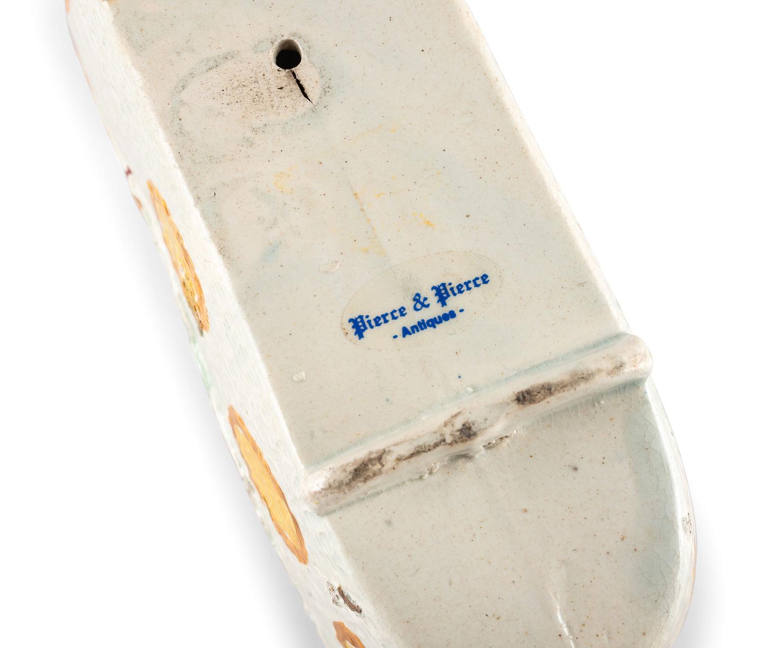 A Staffordshire Pearlware Figure of a Child in a Cradle