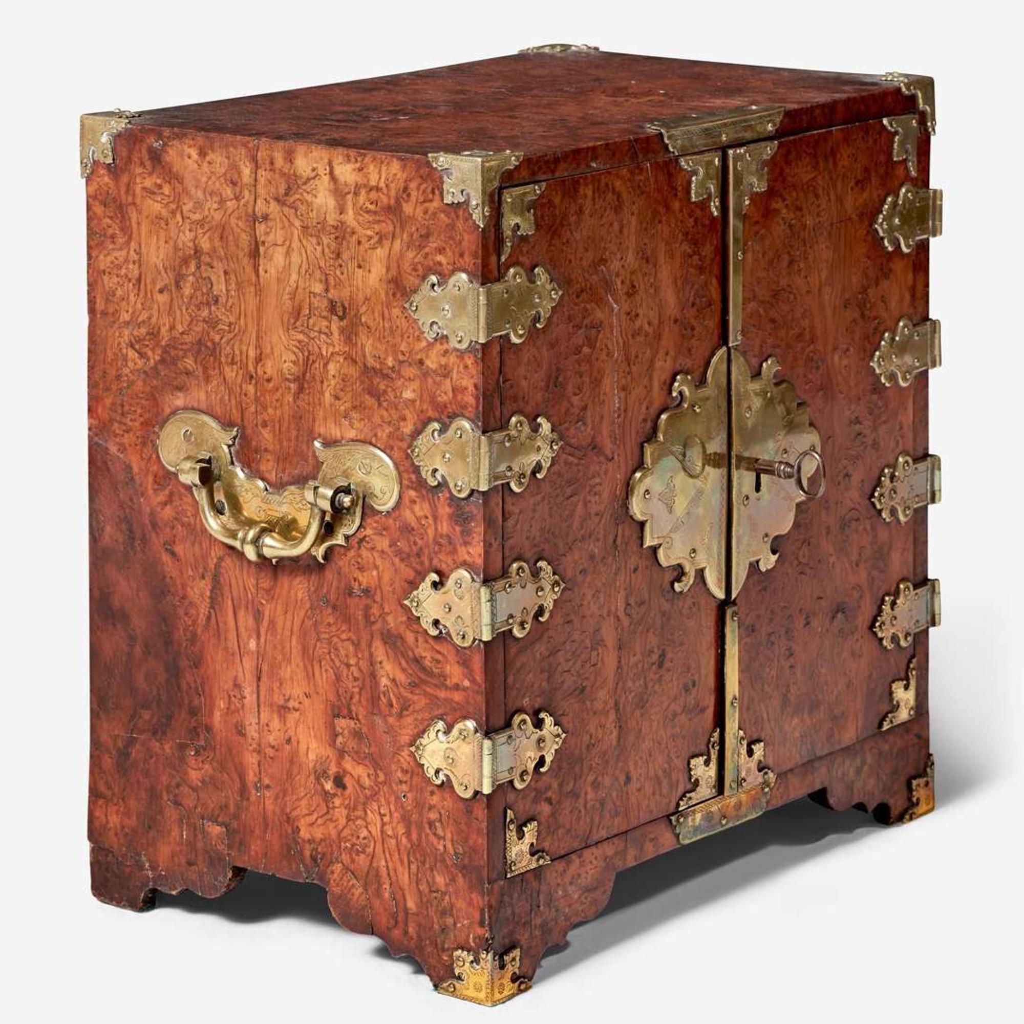 A Queen Anne brass-mounted burl yew table cabinet circa 1710