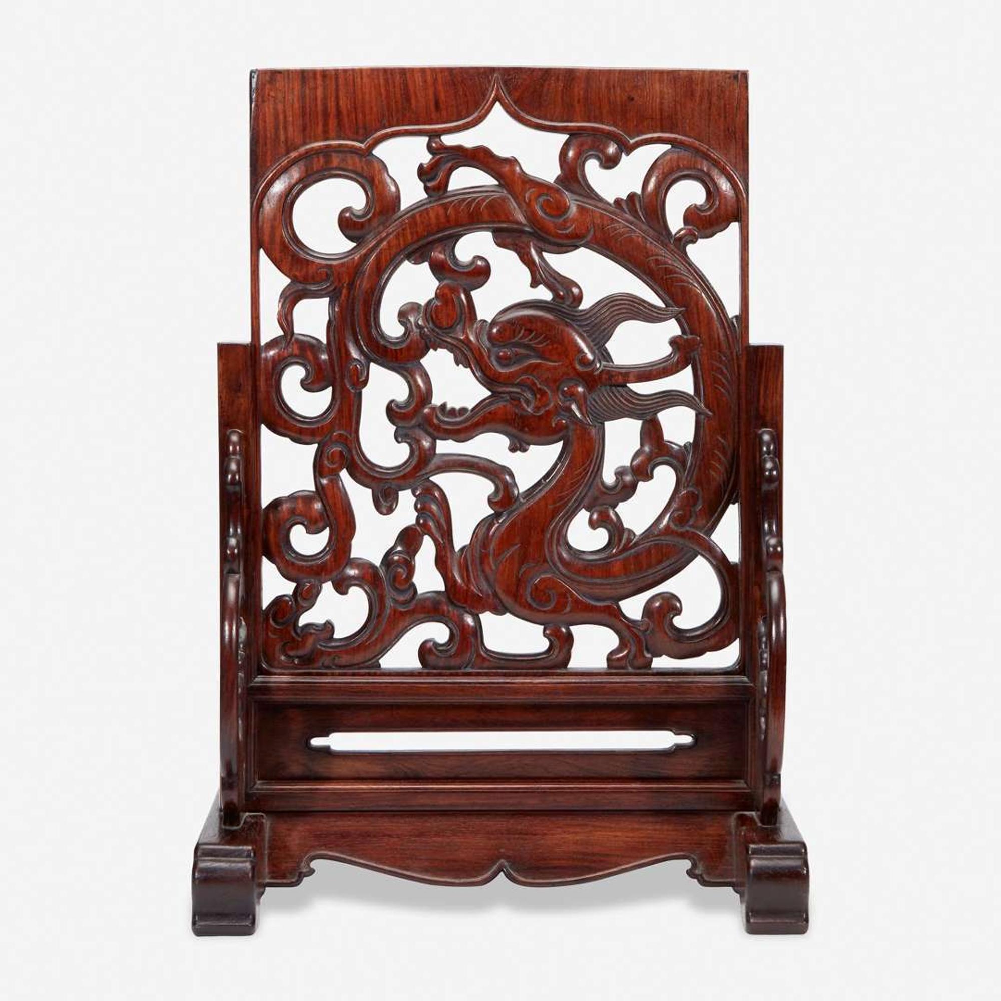 A Chinese carved and pierced huanghuali "dragon" panel, in later hardwood stand 黄花梨镂雕龙纹木板 后配底座 The panel late Ming/Qing dynasty ??????