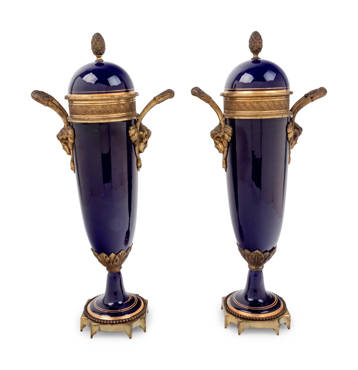 A Pair of Sèvres Style Gilt Metal Mounted Painted and Parcel Gilt Porcelain Urns
