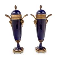 A Pair of Sèvres Style Gilt Metal Mounted Painted and Parcel Gilt Porcelain Urns