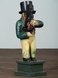 A Carved Wood Figure of a Navigator