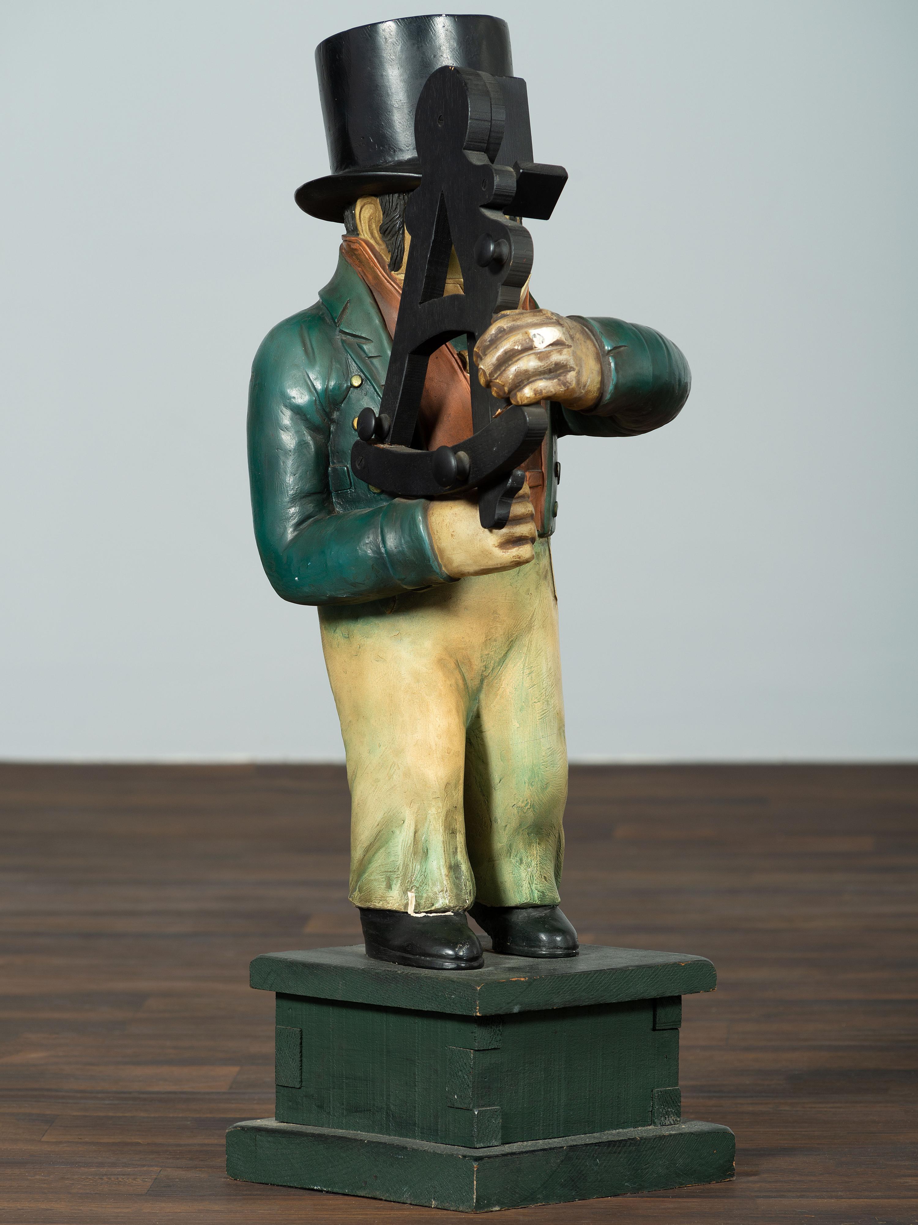 A Carved Wood Figure of a Navigator