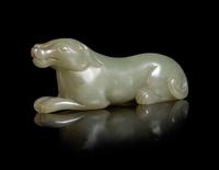 A Carved Celadon Jade Figure of a Hound Length 3 inches.