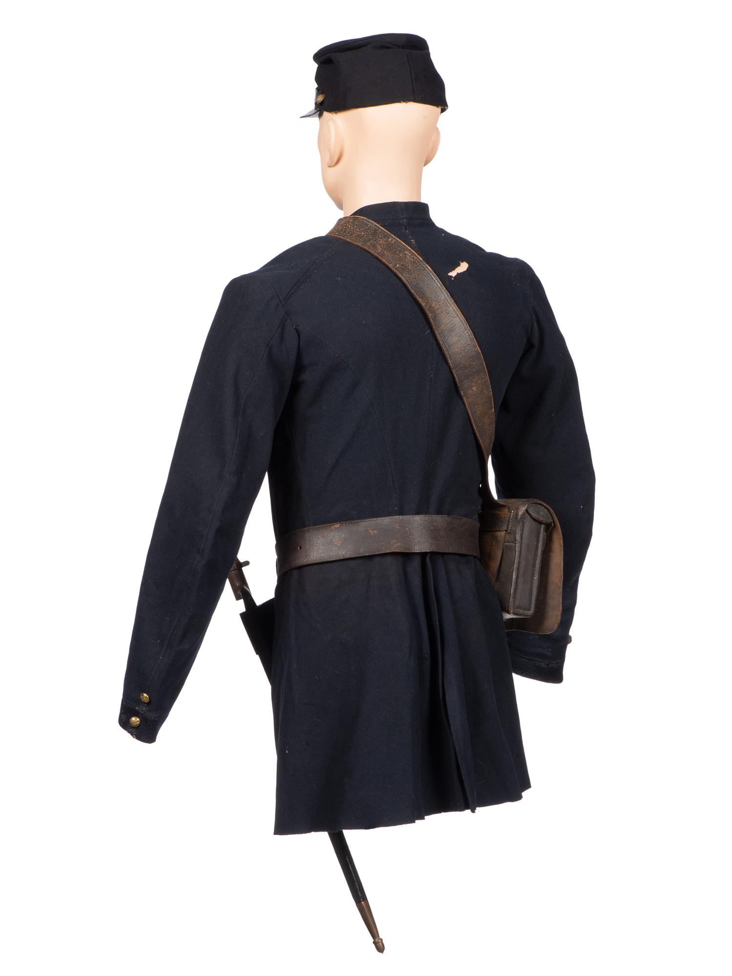 [CIVIL WAR]. A collection of items attributed to Thomas W. Johnson, Co. K, 4th Delaware Infantry, incl. frock coat, cap, belt rig, and cartridge box.