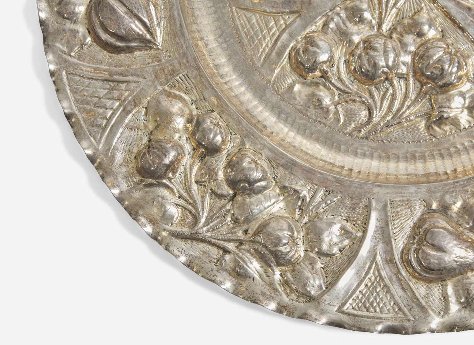 A Portuguese silver repoussé charger, 19th / 20th century