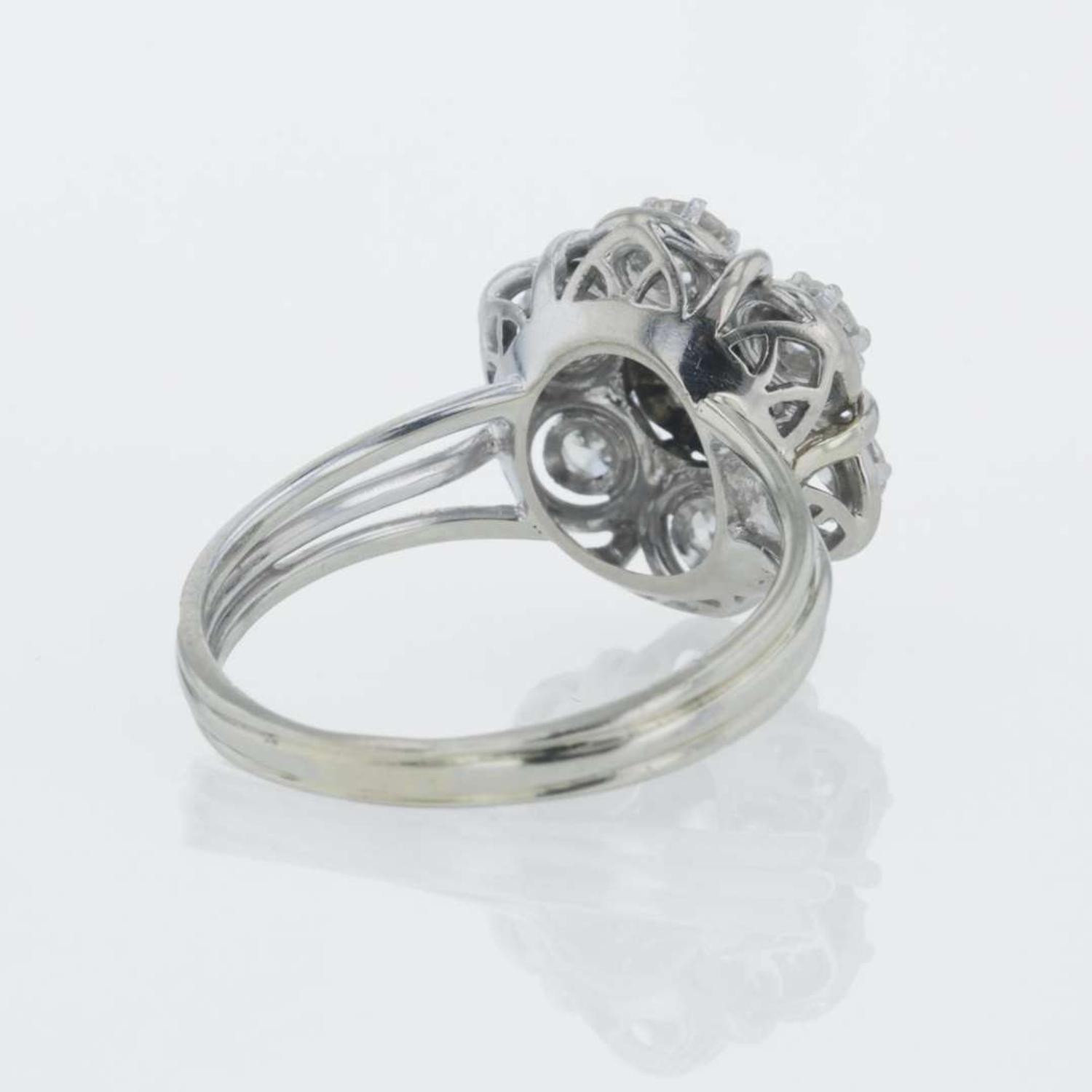 A 14K white gold and diamond ring