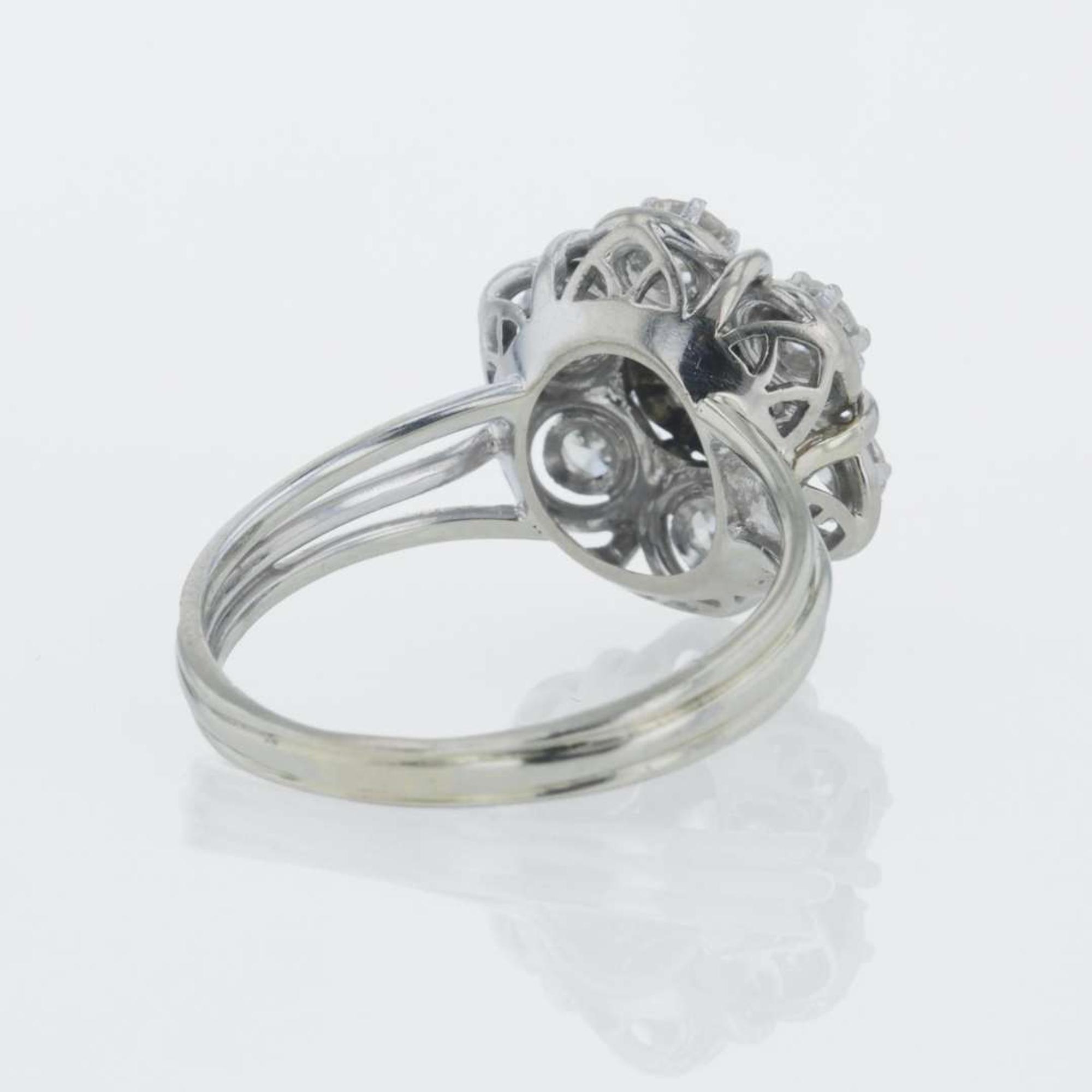 A 14K white gold and diamond ring